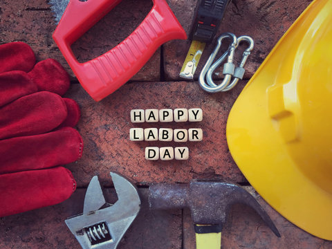 Labor Day concept. HAPPY LABOR DAY written on wooden blocks. With background of working tools.