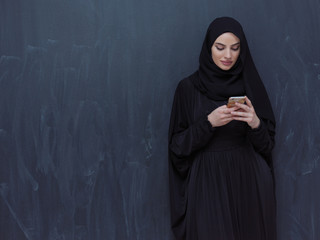 young modern muslim business woman using smartphone