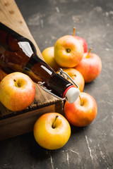 Apple cider in dark bottle made of own farm apples. Selective focus. Shallow depth of field.