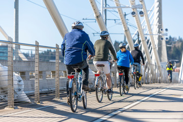 Group of amateur cyclists rides on bikes across the Tilikum Crossing Bridge enjoying an informative...