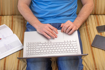 Man hands working at a laptop Distance learning online education and work.
