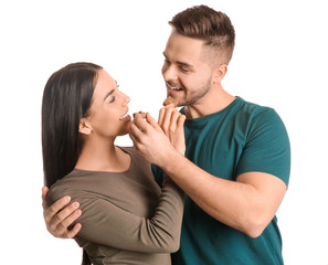 Beautiful young couple with tasty chocolate on white background