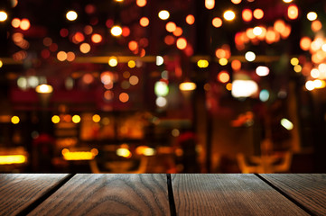 blur bokeh of bar party dark night light background with wood table background