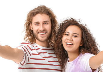 Obraz premium Young couple taking selfie on white background