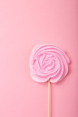 Pink  Rose candy in pastel colors on a wooden stick on a grey  background, Valentine, Mother's Day.
