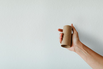 Woman holding an empty toilet paper roll during coronavirus pandemic mockup
