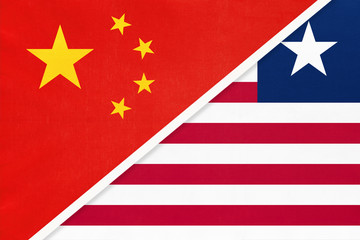 China or PRC vs Liberia national flag from textile. Relationship between Asian and African countries.