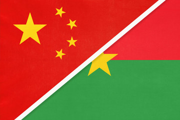 China or PRC vs Burkina Faso national flag from textile. Relationship between Asian and African countries.
