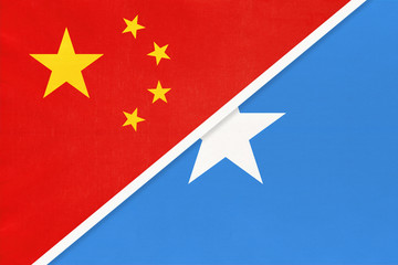 China or PRC vs Somalia national flag from textile. Relationship between Asian and African countries.