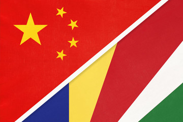 China or PRC vs Seychelles national flag from textile. Relationship between Asian and African countries.