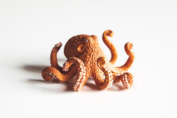 Closeup of octopus toy on white background.