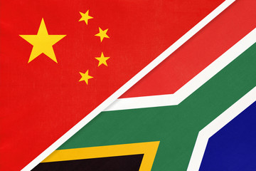 China or PRC vs South Africa national flag from textile. Relationship between Asian and African countries.