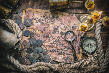 Pirate captain desk with various adventure accessories. Treasure map on the table.