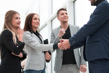 young businesswoman shaking hands with her business partner