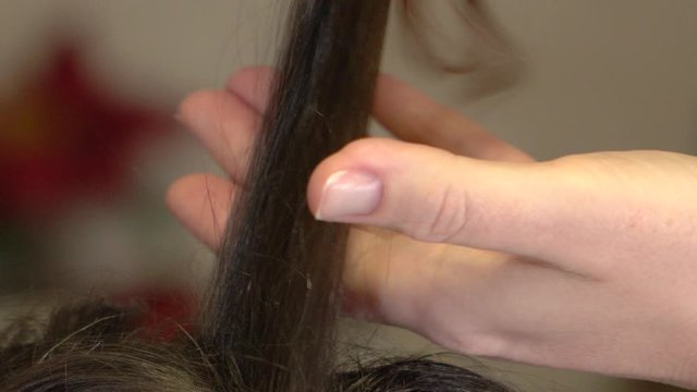 Gentle stroking a lock of female hair