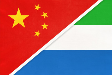 China or PRC vs Sierra Leone national flag from textile. Relationship between Asian and African countries.