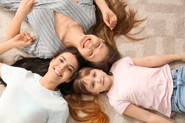 Happy lesbian couple with little adopted girl at home