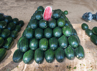 These pile of watermelons are beautiful and tasty, ready to eat.Watermelon (Citrullus lanatus) is a plant species in the family Cucurbitaceae, a vine-like flowering plant originating in West Africa.