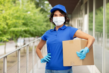 Obraz na płótnie Canvas health protection, safety and pandemic concept - delivery woman in face protective medical mask and gloves holding parcel box over city street background