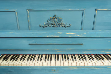 Keys of an old piano. Details of the design of the recolored blue and gold piano. Stucco on the piano © Yashkin Ilya
