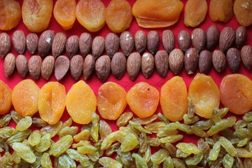 Assortment of nuts,dried fruits and seeds on a wood background.Dried fruits and nuts, symbols of...