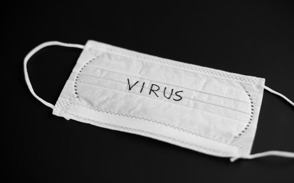 medicine, healthcare and safety concept - medical face mask for protection from virus on black background