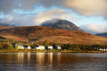 Panoramic view of the valley near the Paps of Jura under the colorful stormy sunset sky....