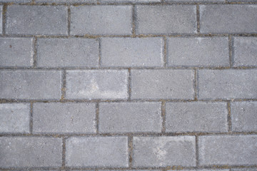 Obraz premium Background of asphalt gray rectangular tiles.