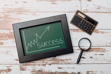charts of economics and stock markets on a chalk board. financial crisis concept.