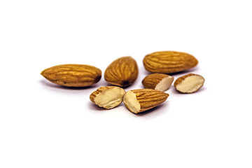 A close up of almond seeds on white isolated background. food and kitchen concept.
