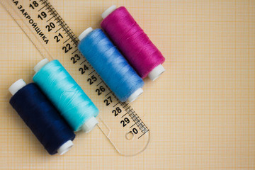 thread in spools and cutter line for sewing