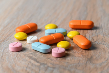 Assorted color tablets close-up on the table. Concept of protection and treatment of coronavirus infection. Copy space.