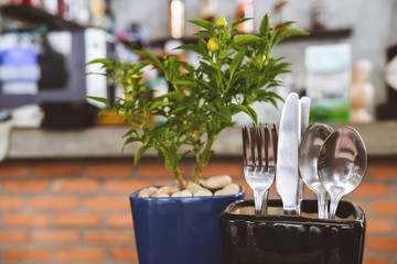 Fototapeta na wymiar Cutlery set creatively placed on the restaurant table. Modern design hipster concept, soft focus