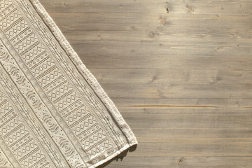 Vintage lace pattern cloth and wood board texture background. retro ornate tablecloth on wooden table surface, top view. - obrazy, fototapety, plakaty
