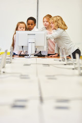 Group of kids learns together on the PC