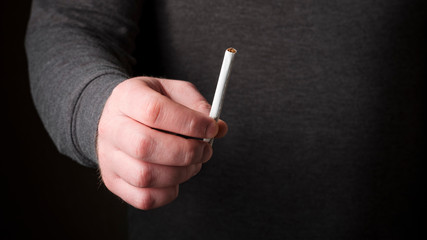 Male holding a cigarette in hand. Stop smoking cigarettes concept. Quit bad habit, healthy...