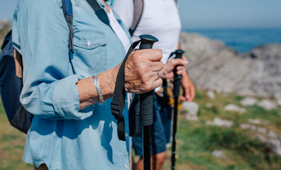 Senior man and woman practicing trekking outdoors