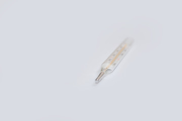 On white surface in center is placed a thermometer to measure the temperature. Glass mercury...