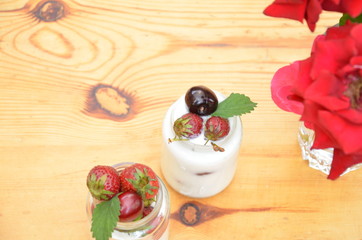 Healthy breakfast home made pudding or yogurt or granola, strawberries, cherry, berry,  yogurt in a bowl. Vegetarian concept food. pudding or cocktail on of green foliage