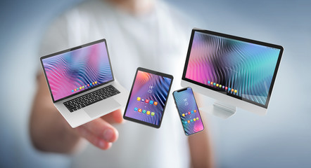 Businessman connecting modern smartphone tablet laptop and computer 3D rendering
