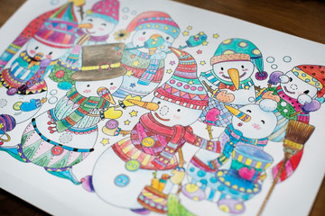 Colored snowmans in a drwing book by a child
