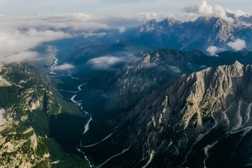 Italian Dolomites, Tre Cime - Rifugio Lavaredo - stony road around Tre Cime .Peak in the clouds. Aerial shot.