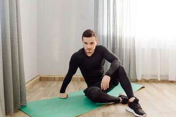 young man making sport exercises at home