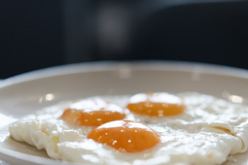 Three fried eggs for healthy breakfast.