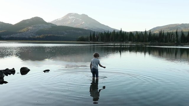 Little Boy Exploring Volcanic Mountain Lake outside of Bend Oregon at Sunset