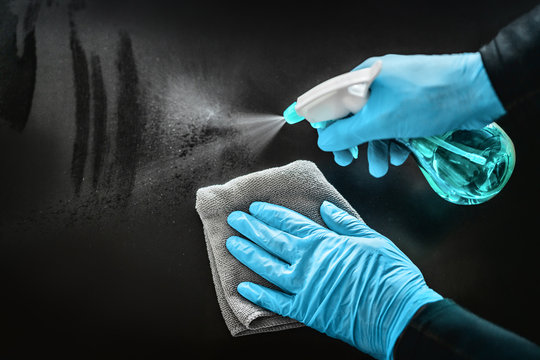 Surface cleaning disinfecting home with sanitizing antibacterial wipes protection against COVID-19 spreading wearing medical blue gloves. Sanitize surfaces prevention in hospitals and public spaces.