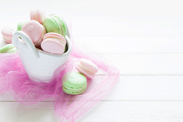 Colorful French macaroons , pink and green macaroons  on wooden board.