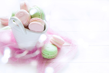 Colorful French macaroons , pink and green macaroons  on wooden board.