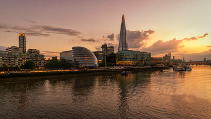 Obraz na płótnie Canvas Panoramic view of the Shard and the HMS Belfast ship from the Tower Bridge along the Thames river at sunset, London, England, GB