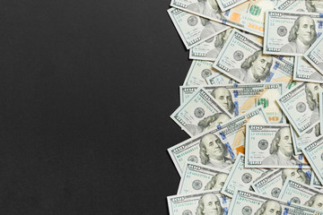 One hundred dollar banknotes on colored background top view, with empty place for your text...